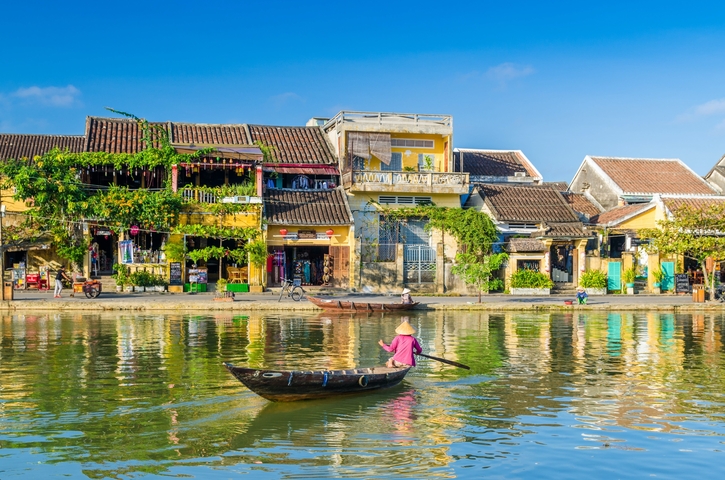 Colorful houses reflecting on the river in Hoi An