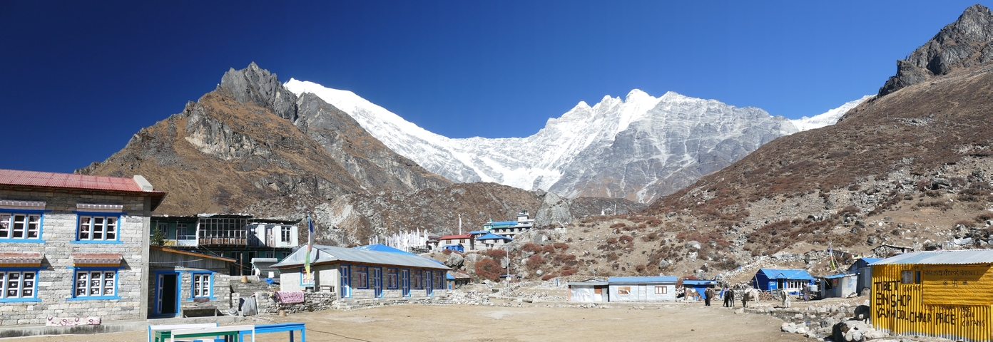 Village with mountains and blue skies.
