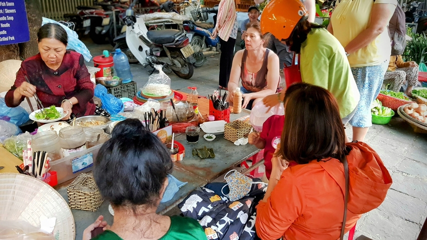 Market scene with people eating and socializing