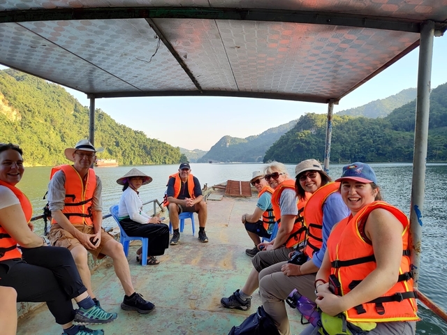       Group of people on a boat in a scenic lake
  