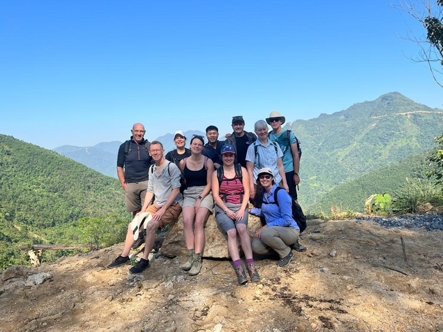 Group of hikers posing on a mountain trail
