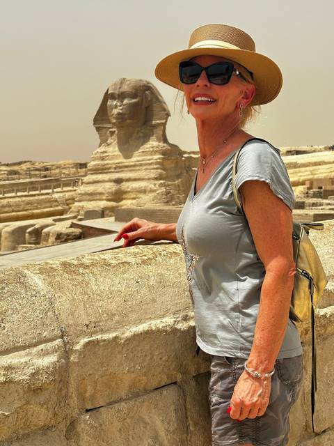 Person posing with the Sphinx in the background.