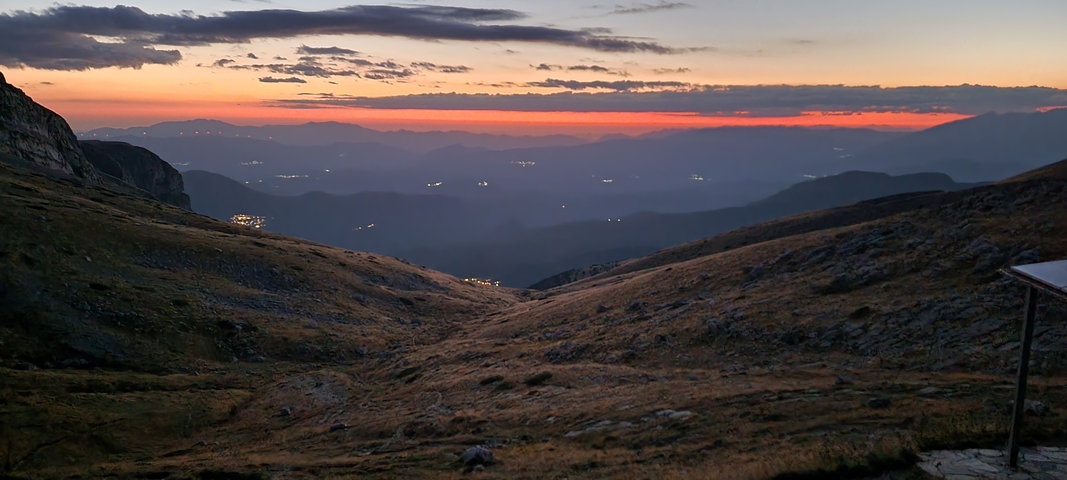 Sunset view over mountain ridges and valleys.