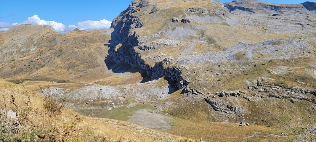       Wide landscape of rocky mountains and arid terrain.
  