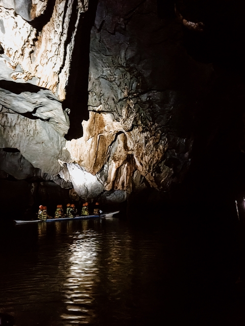 People on a boat tour inside a cave.