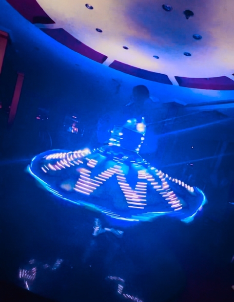 Performance with a person in illuminated costume.