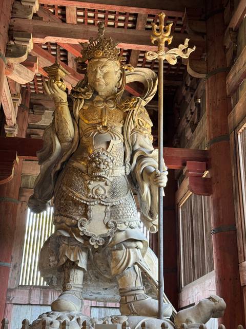 Close-up of a wooden statue of a samurai in a temple.