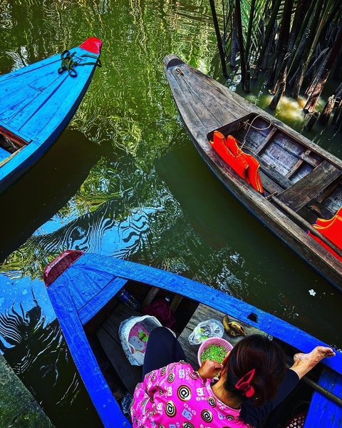 Traditional wooden boats docked in a canal.
