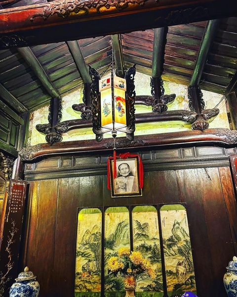 Interior of an old wooden building with a portrait.