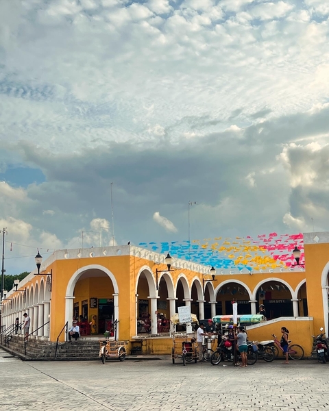       A building with colorful flags strung above.
  