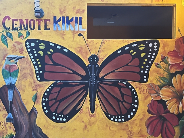       A mural with a butterfly and floral elements.
  