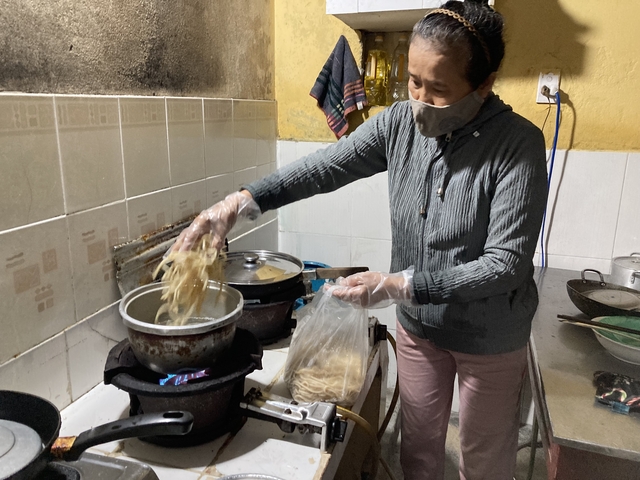 A woman preparing food in a kitchen.