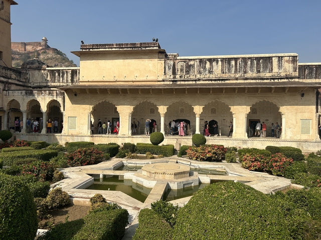       Historic complex with gardens and tourists.
  