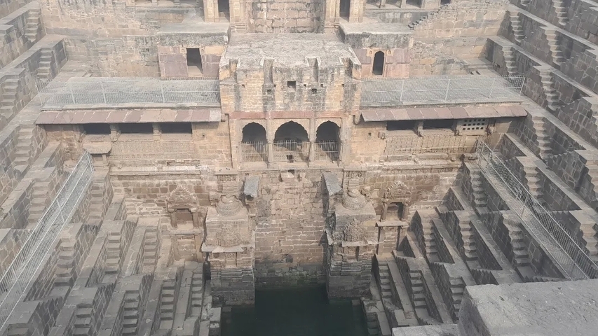 Intricate stepwell architecture with multiple levels and detailed carvings.