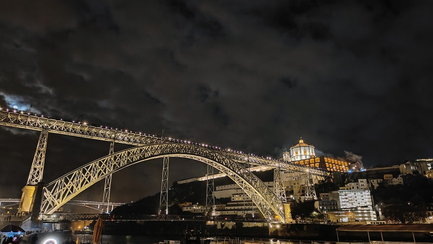       Illuminated bridge and cityscape at night.
  