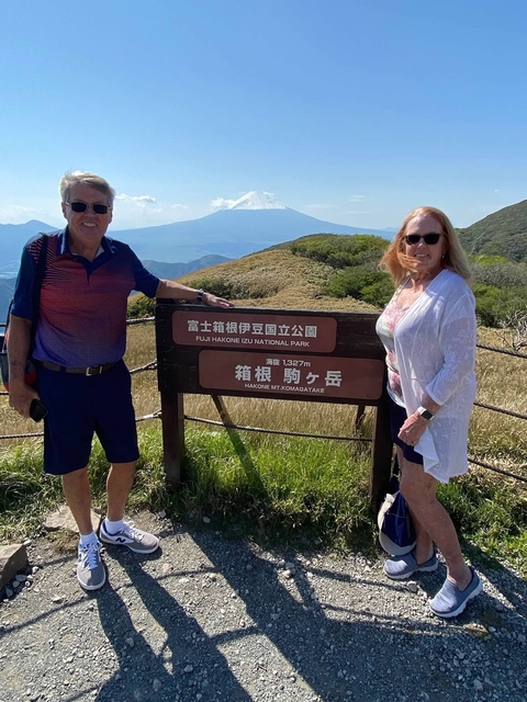 Couple posing by a sign at Fuji-Hakone-Izu National Park.