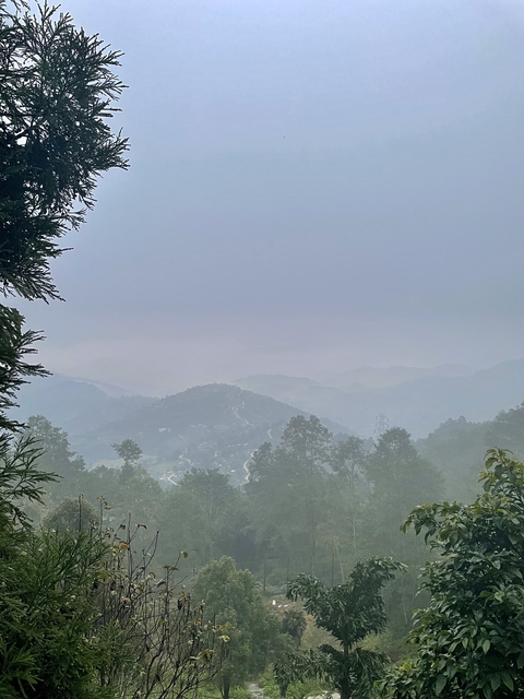       Hazy mountain landscape with distant hills.
  