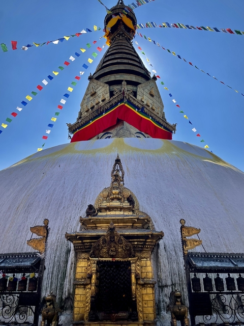       Close-up of Boudhanath Stupa with prayer flags.
  