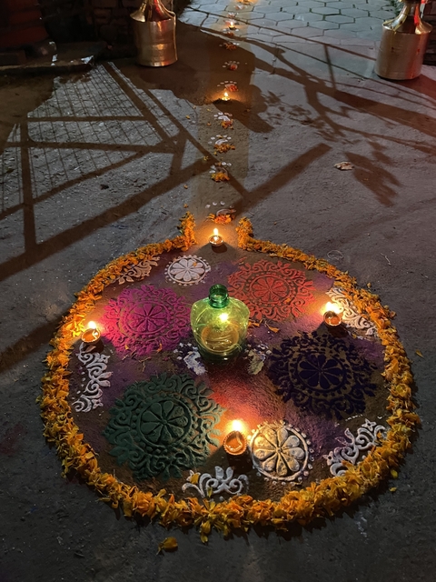       Colorful mandala design with candles and flowers.
  