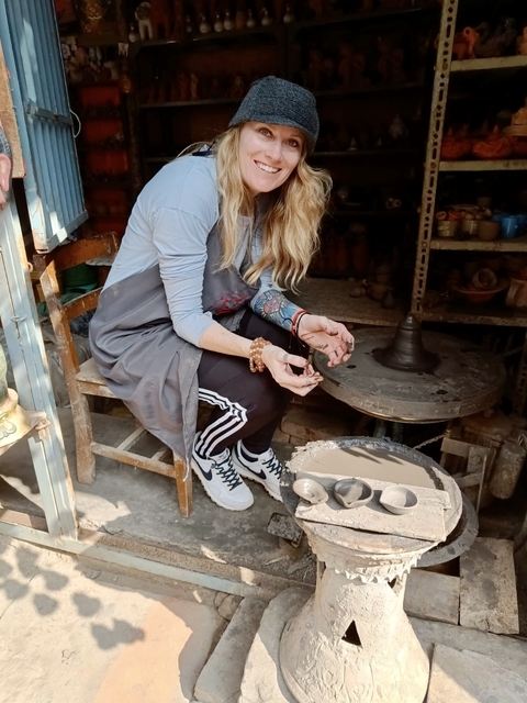       Person participating in pottery-making activity.
  