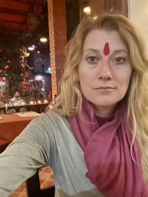       Close-up portrait of a woman in a restaurant setting.
  