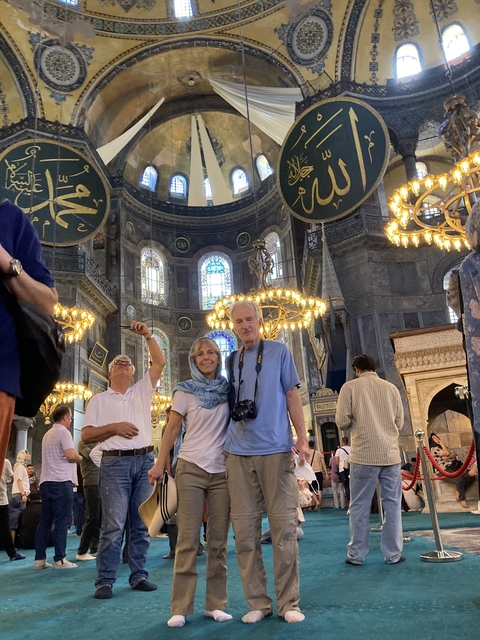 Couple inside a large, ornately decorated building.