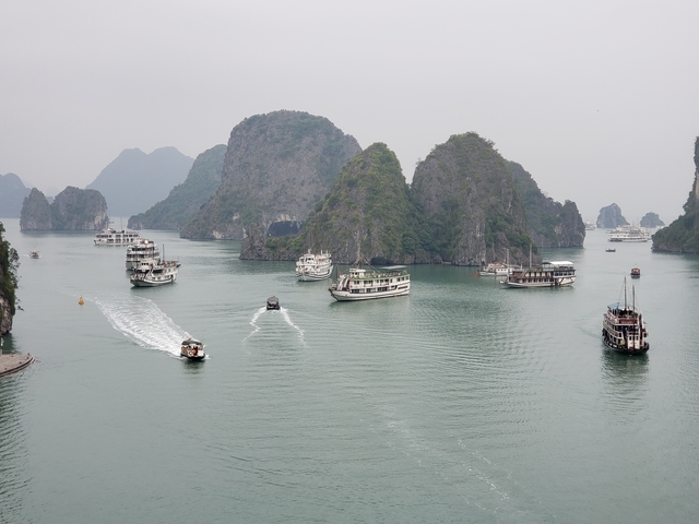 Halong Bay with boats and limestone islands.
