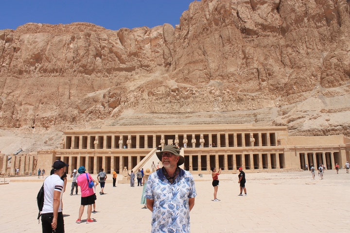       Tourists in front of Hatshepsut Temple with cliff backdrop.
  