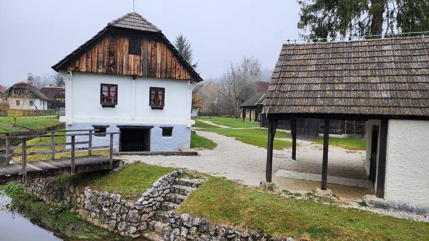 Historical village with wooden houses and cobblestone paths.