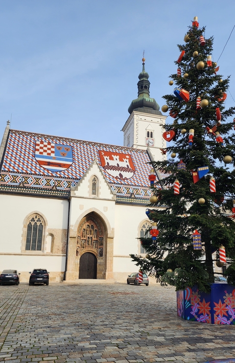       St. Mark's Church with a colorful tiled roof and decorations.
  
