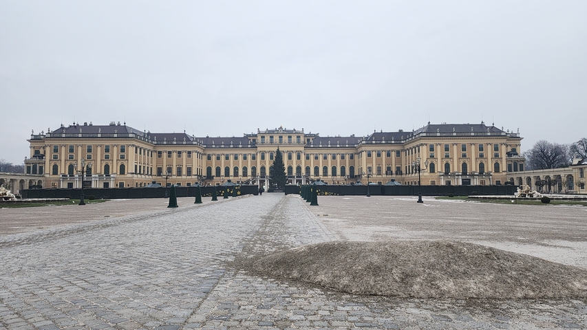       Schonbrunn Palace with expansive gardens and pathways.
  