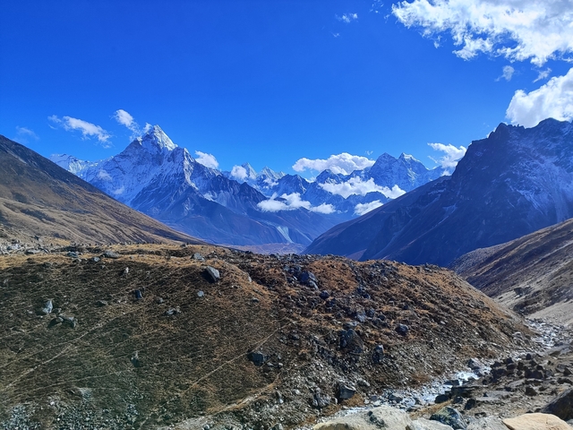       Mountain range with snowy peaks and a valley.
  