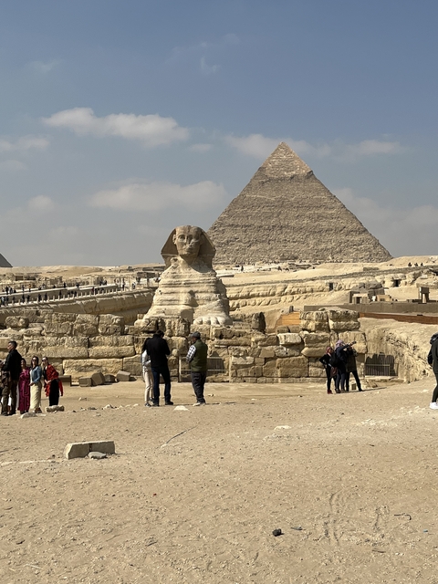Sphinx with pyramids in the background.