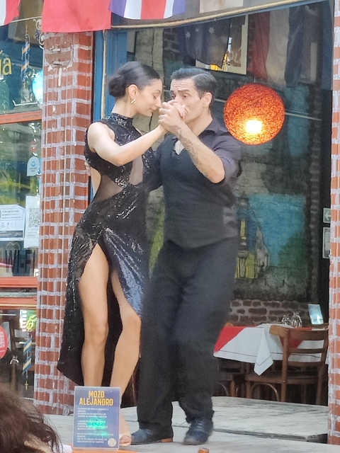       Dancers performing on a street.
  