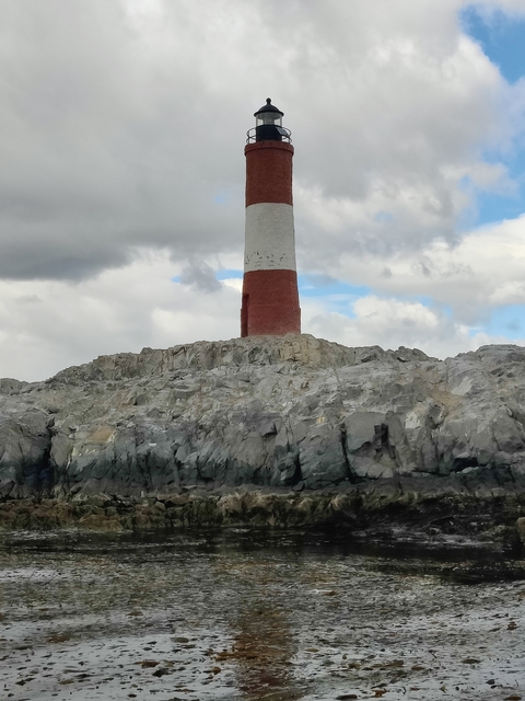       Lighthouse on a rocky island.
  