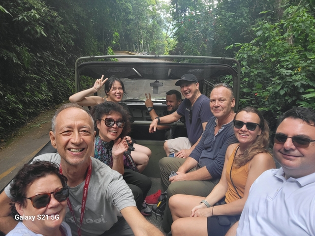       A group of people enjoying a ride in an open vehicle.
  