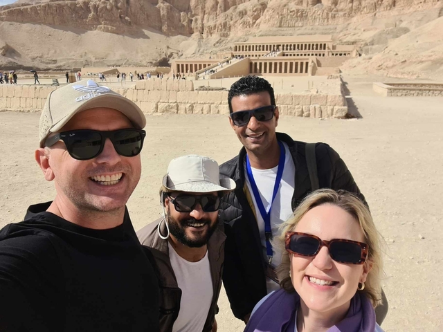 Group of tourists posing at a historical site.