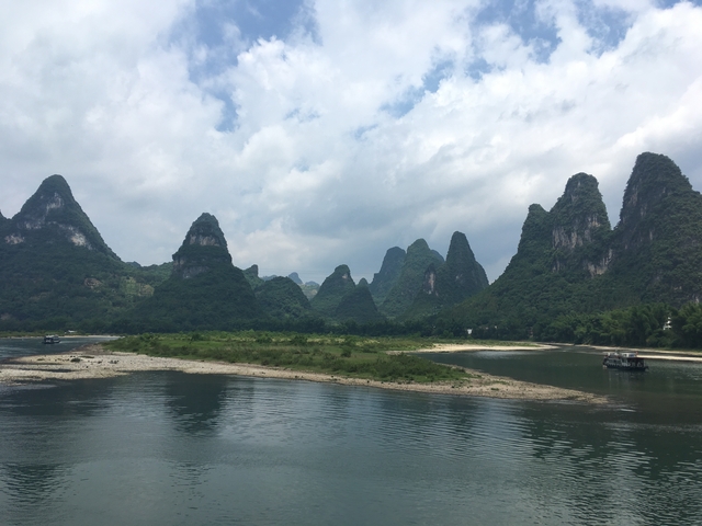 Scenic karst mountains and a river with boats