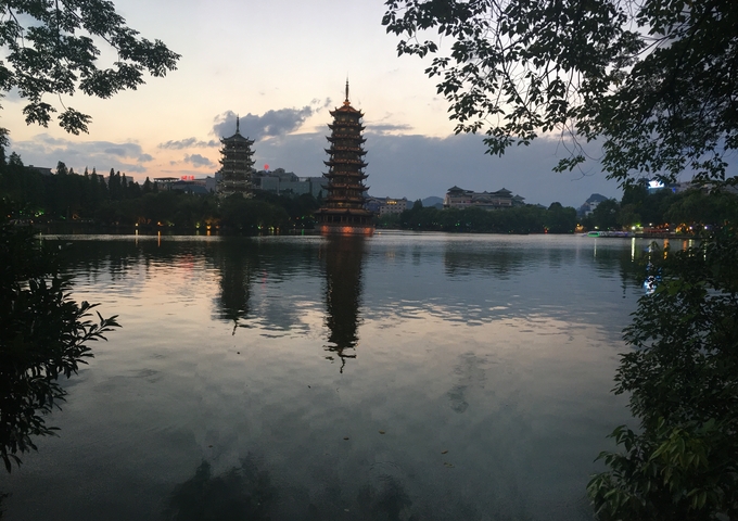 Pagodas reflecting on a lake at sunset
