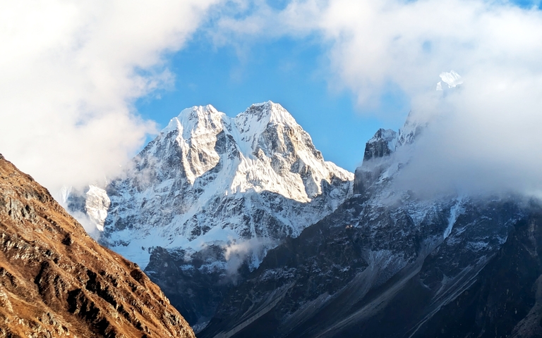       Majestic snow-capped mountains under a clear sky.
  