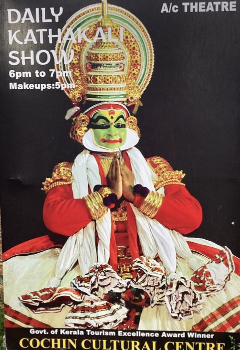 Traditional Kathakali performer in vibrant costume and makeup.