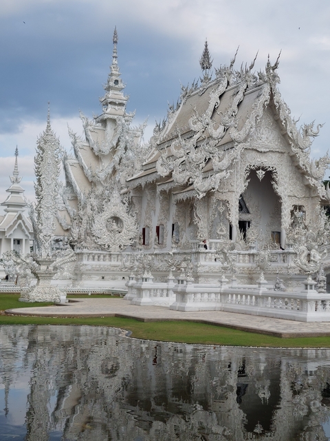       Intricate white temple with ornate detailing.
  