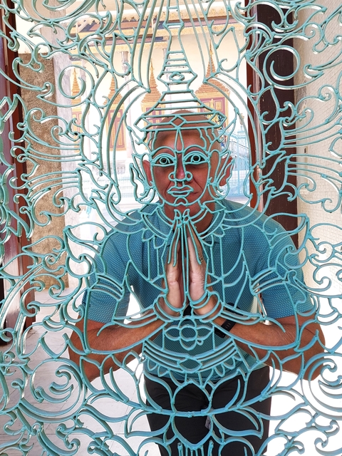 Ornate sculpture of a figure in a traditional gesture.