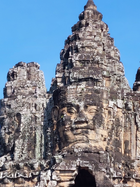      Close-up of intricately carved face on an ancient temple.
  