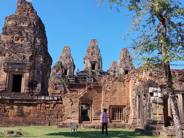 Temple ruins with spires and a clear blue sky.