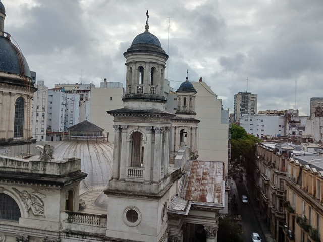 View of historic buildings with domed roofs in a city skyline.