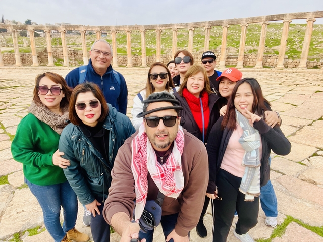       Group posing on ancient stone pavement.
  