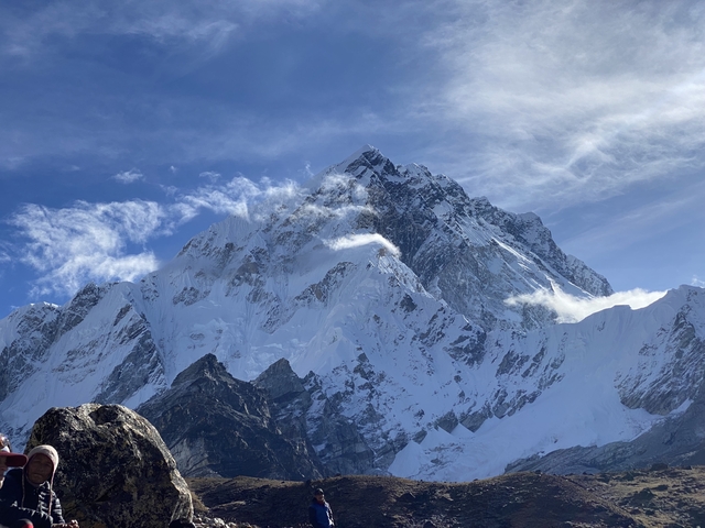       Close-up view of a snow-covered mountain peak against a clear sky.
  