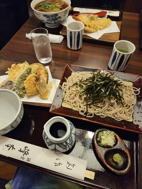 Traditional Japanese soba noodles with tempura and dipping sauce.