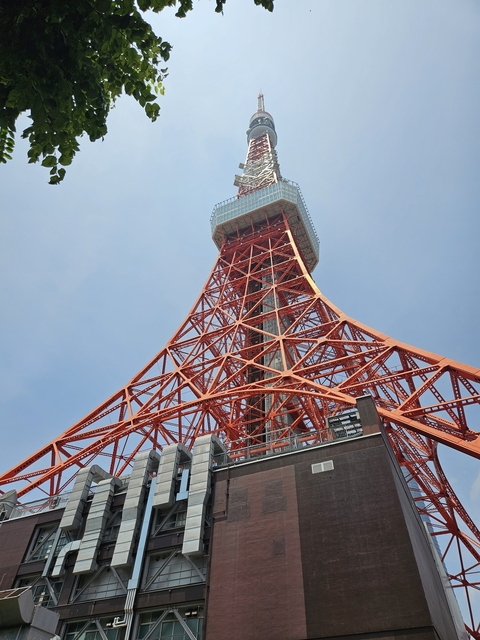       Close-up view of Tokyo Tower against a clear blue sky.
  